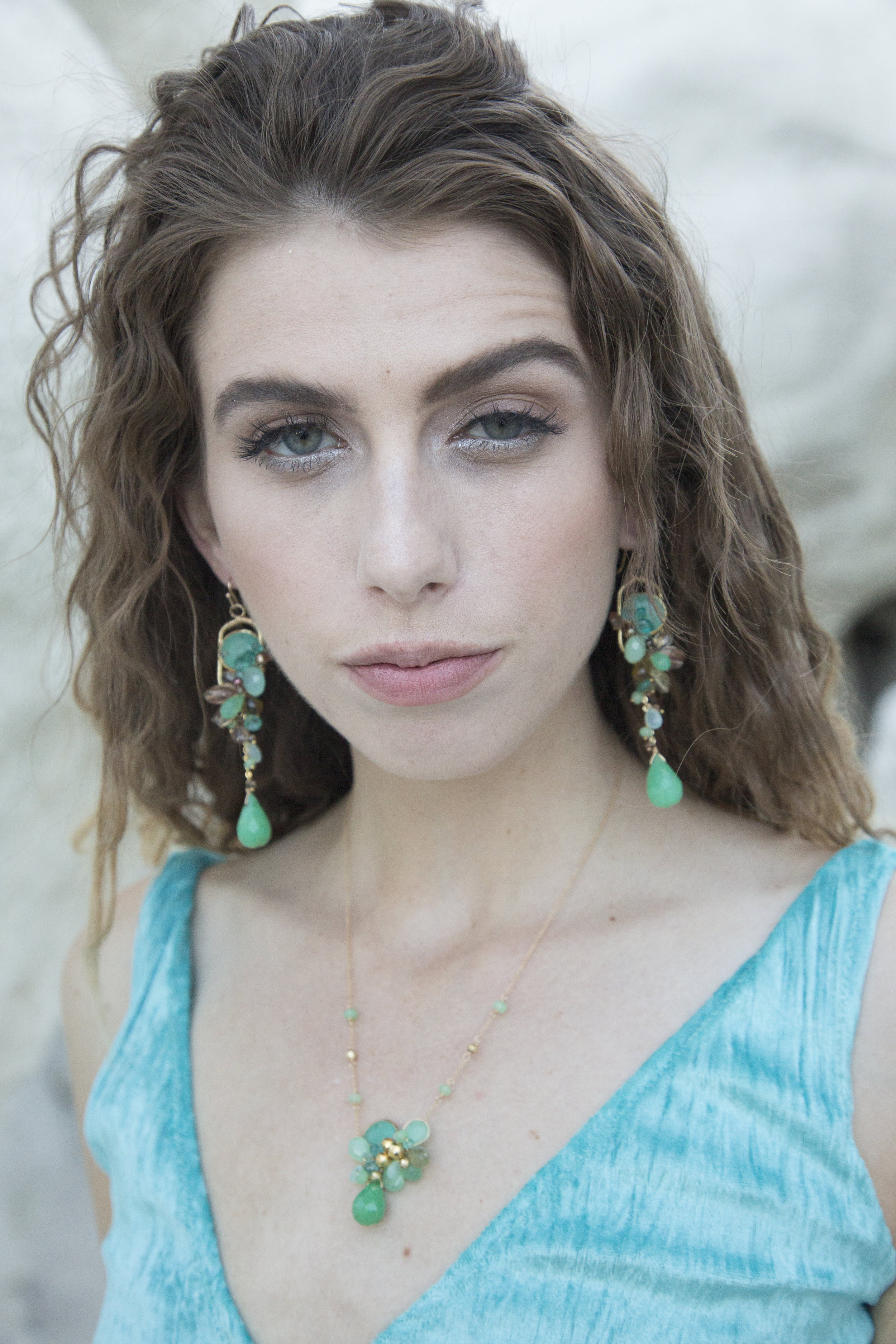 model wearing Gemstone cluster drop statement earrings