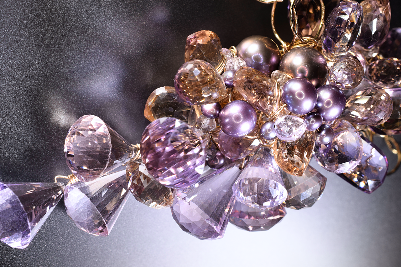 Details of a pink amethyst, ametrine, pearl and gold statement necklace