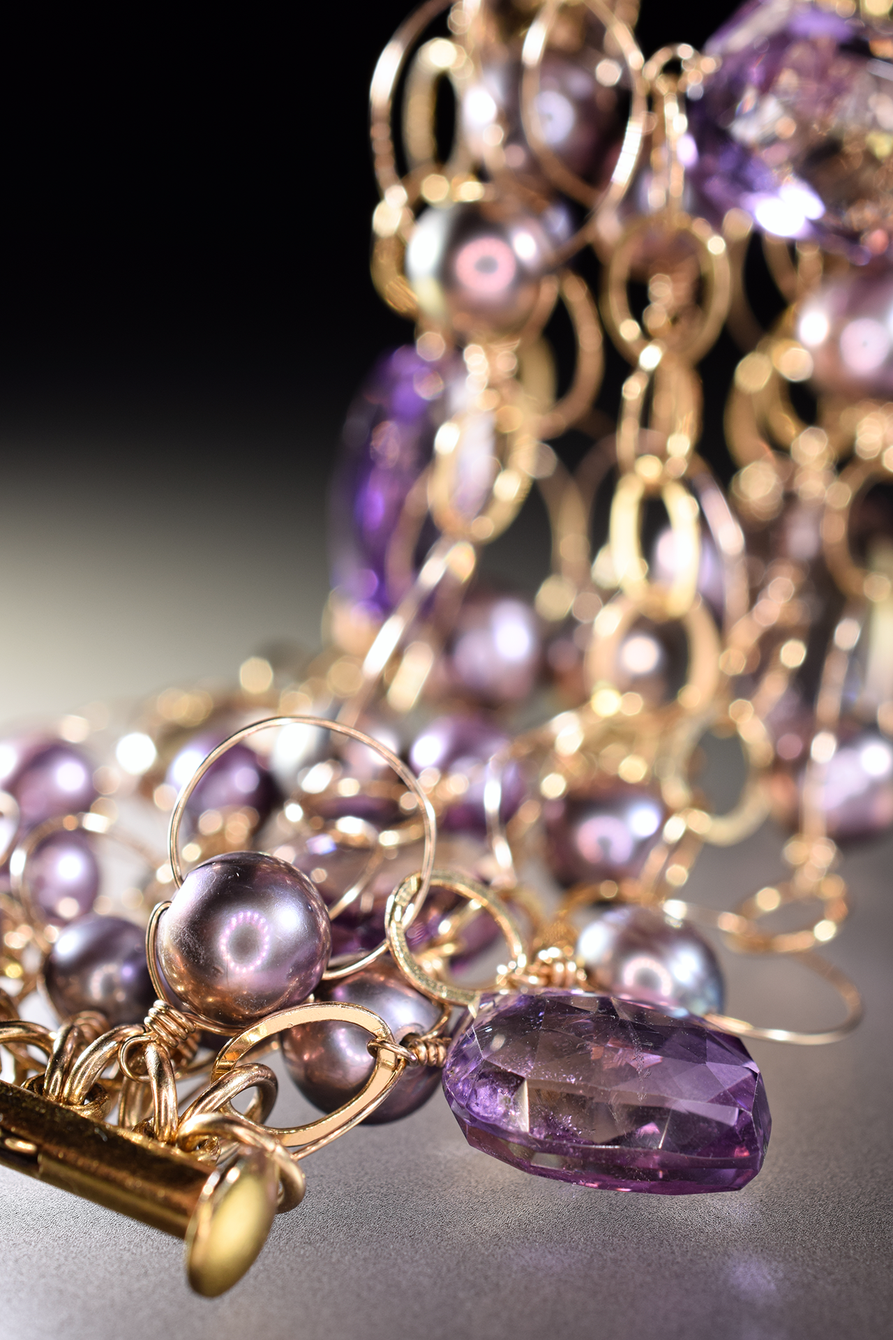 details of ametrine, pearl and gold link statement cuff bracelet