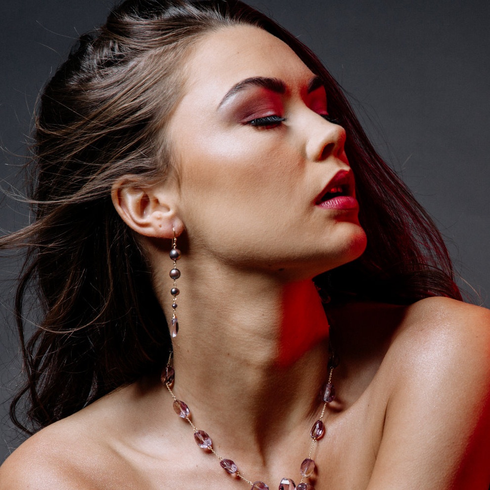 Model wearing pearl and pink amethyst drop earrings