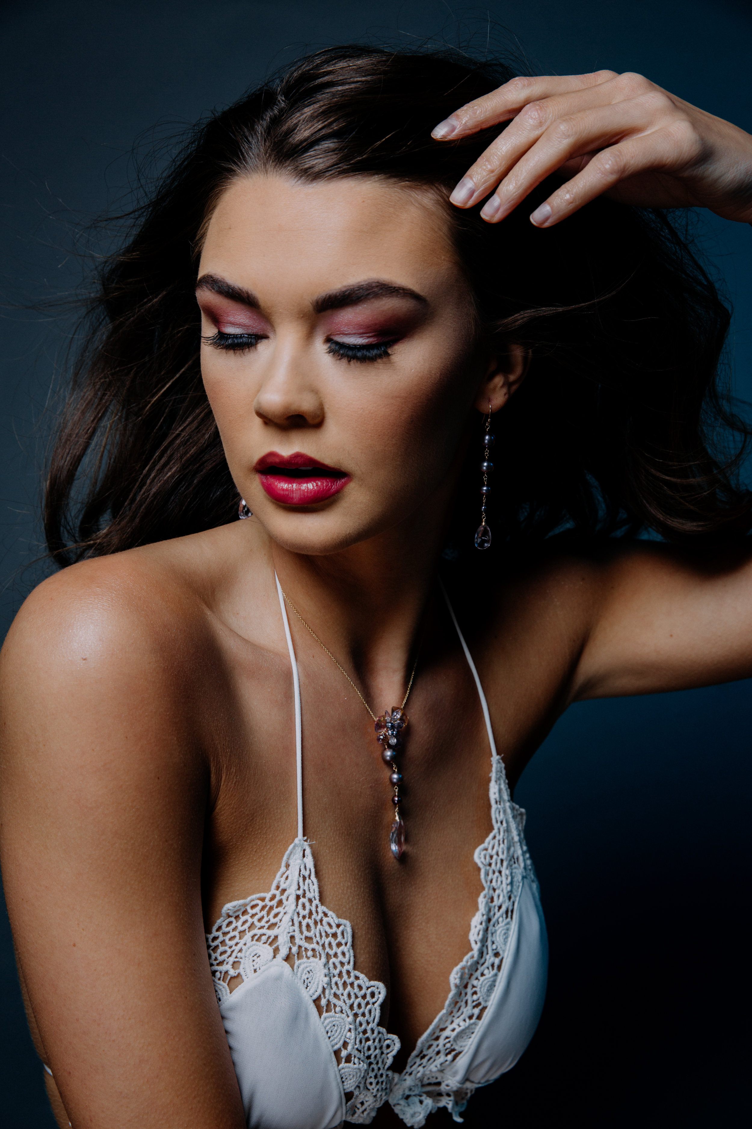 Model wearing pearl and pink amethyst drop earrings