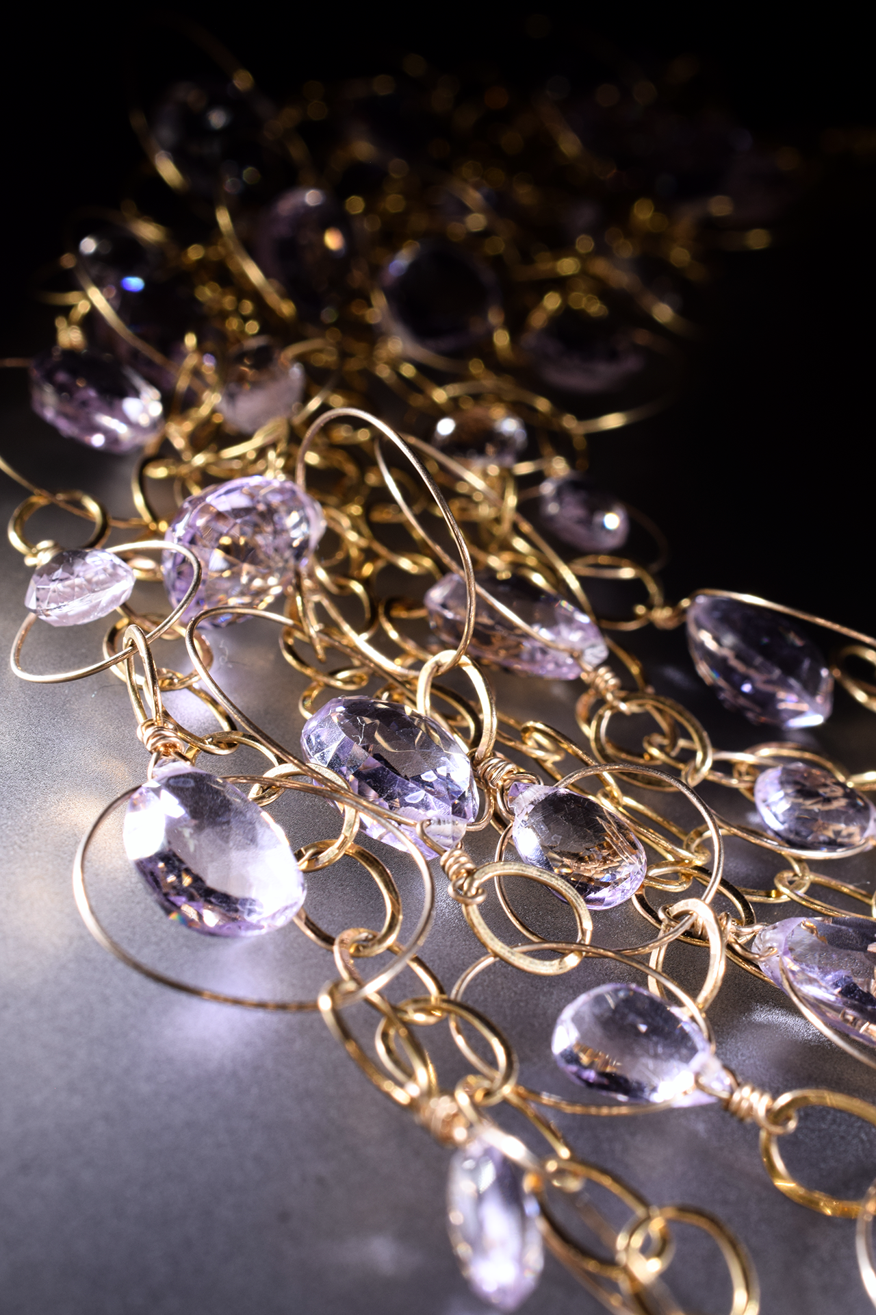 detail of a pink amethyst multi strand gold link statement bib necklace