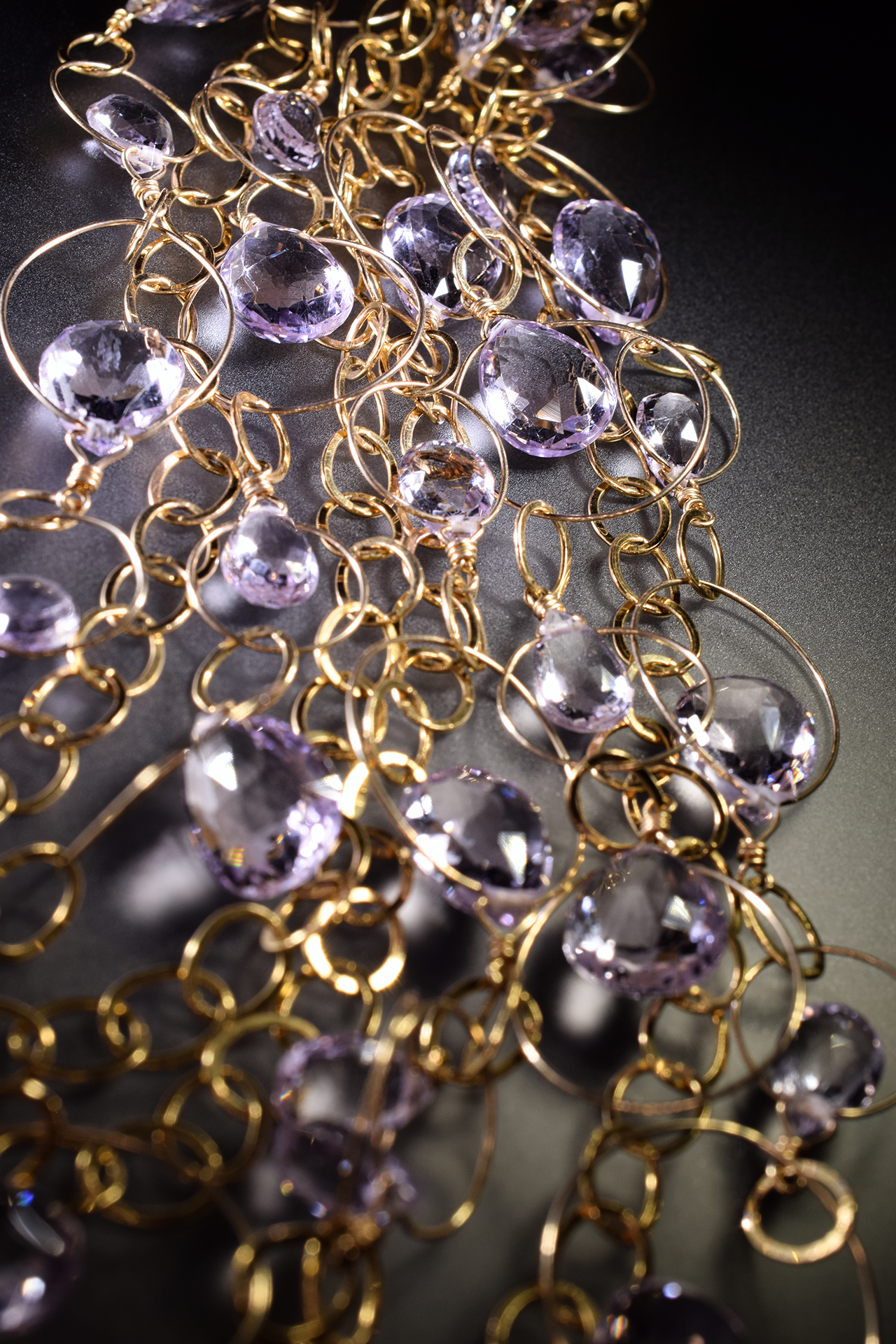 detail of a pink amethyst multi strand gold link statement bib necklace