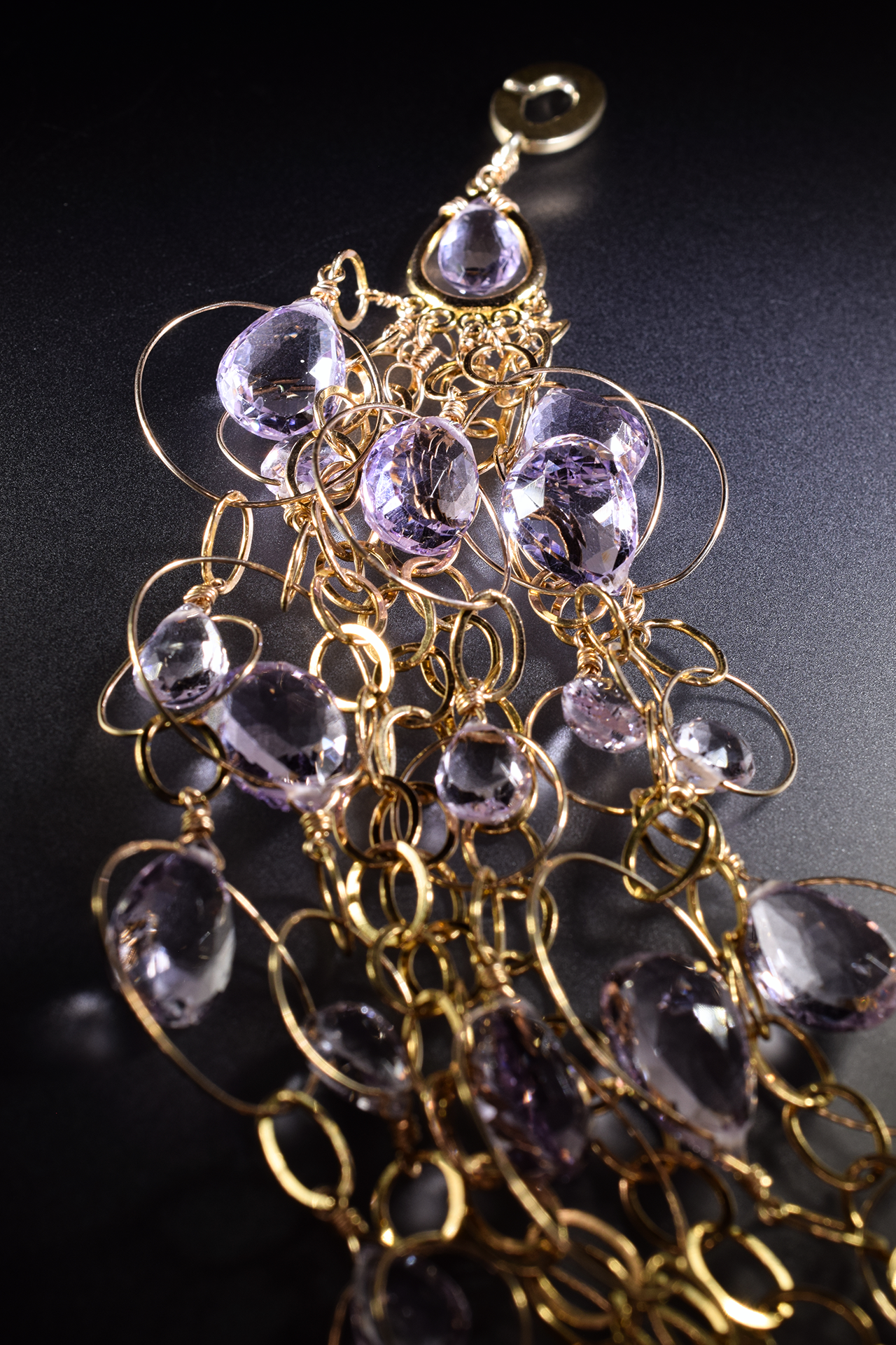 detail of a pink amethyst multi strand gold link statement bib necklace