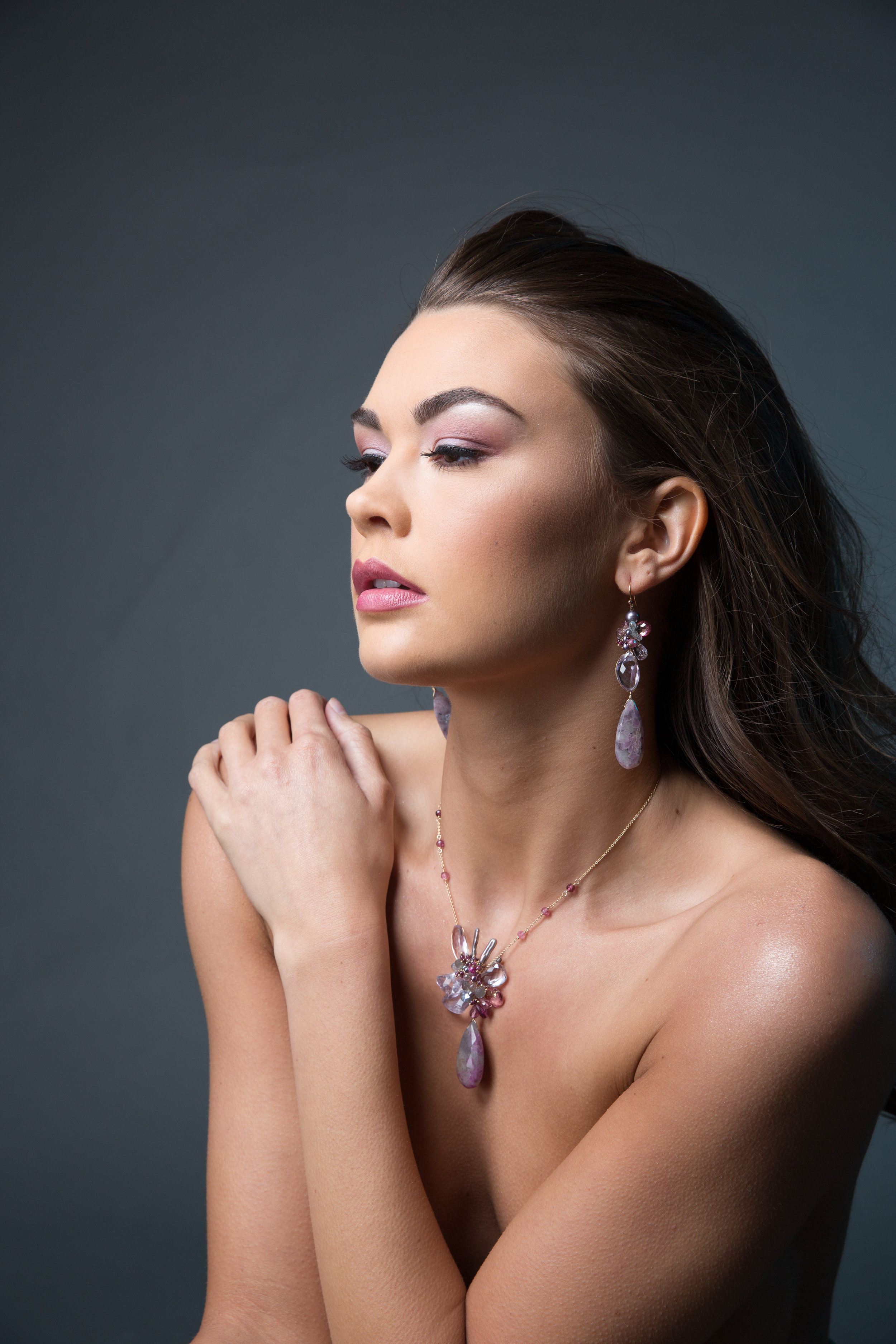 model wearing statement gemstone earrings