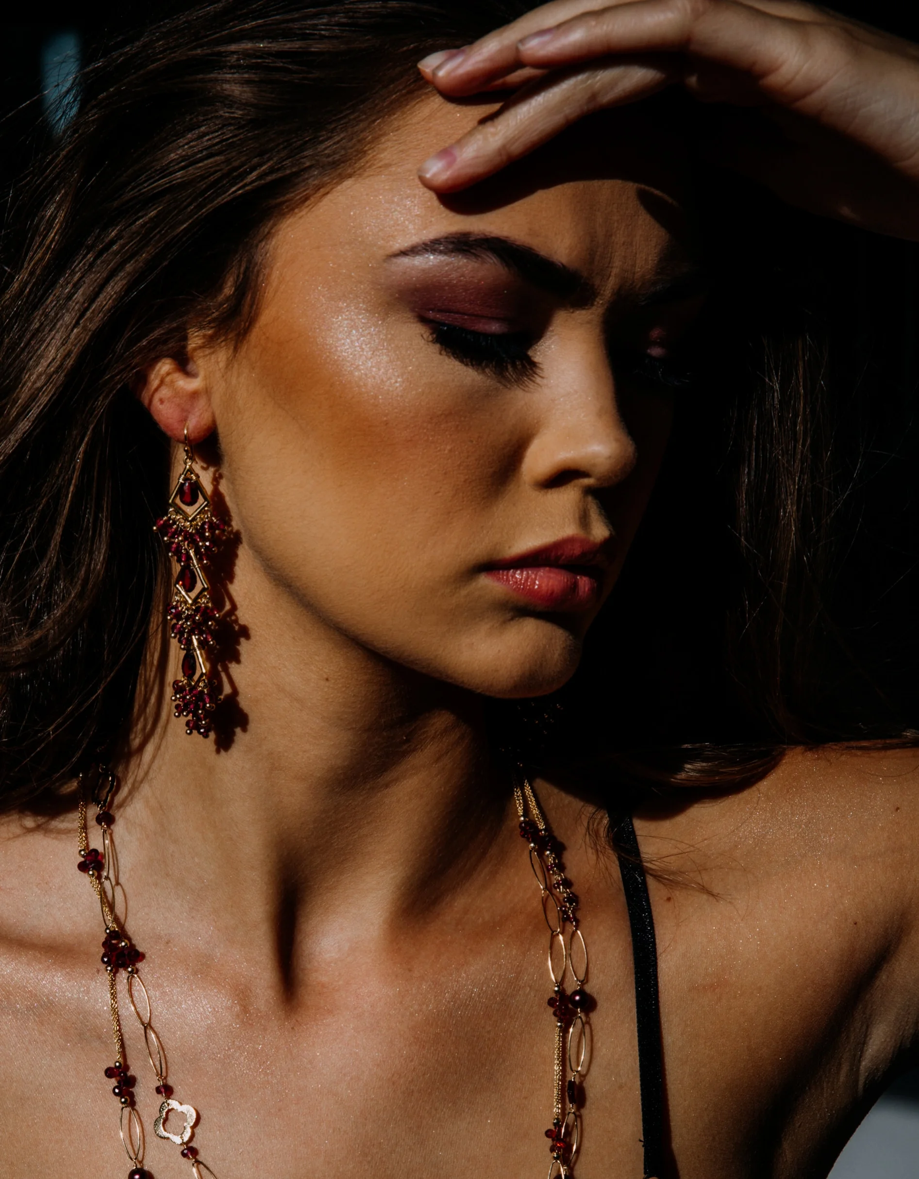 model wearing garnet statement earrings