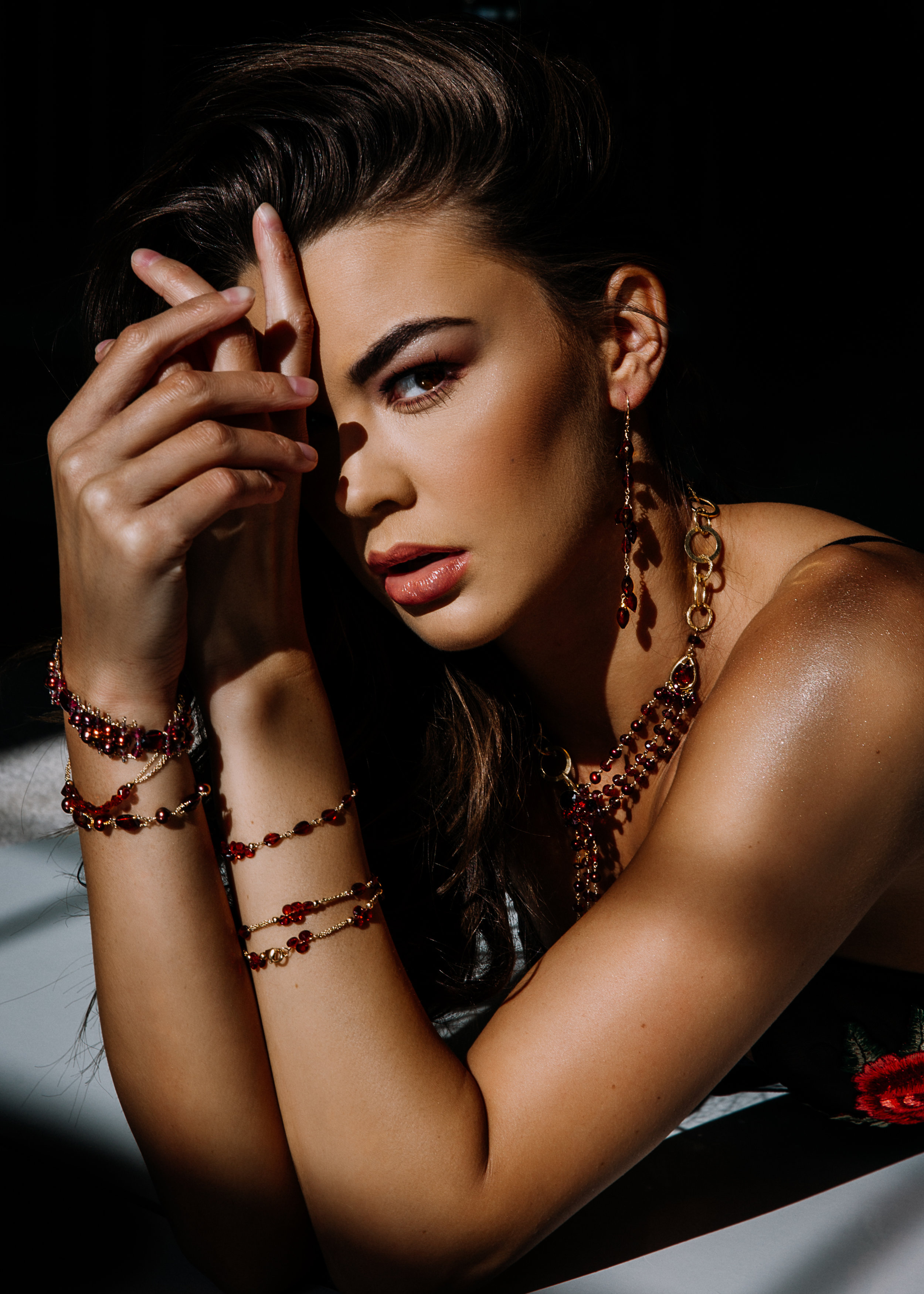 model wearing garnet layering bracelets