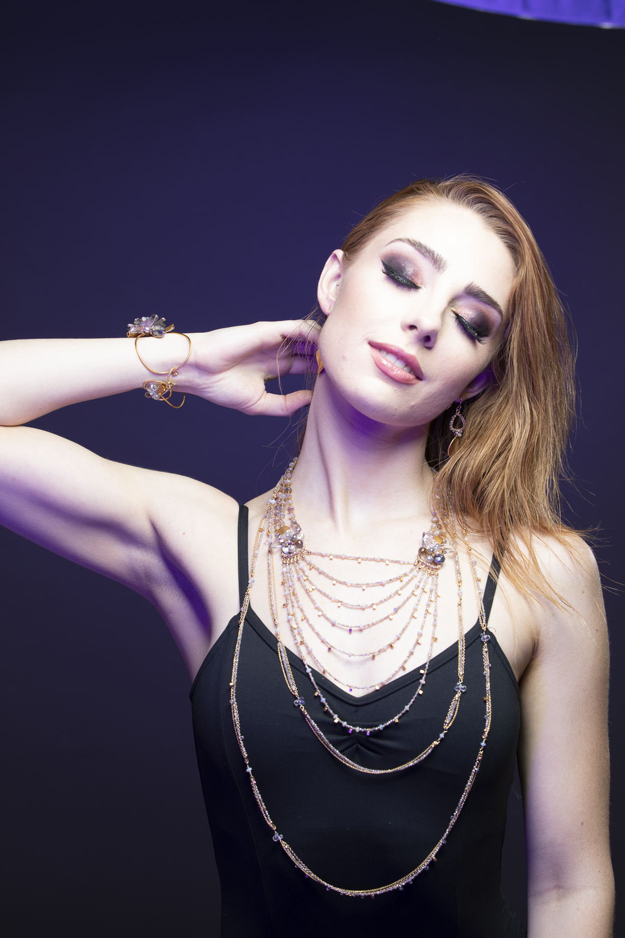 model wearing multi strand gemstone bib statement gold necklace