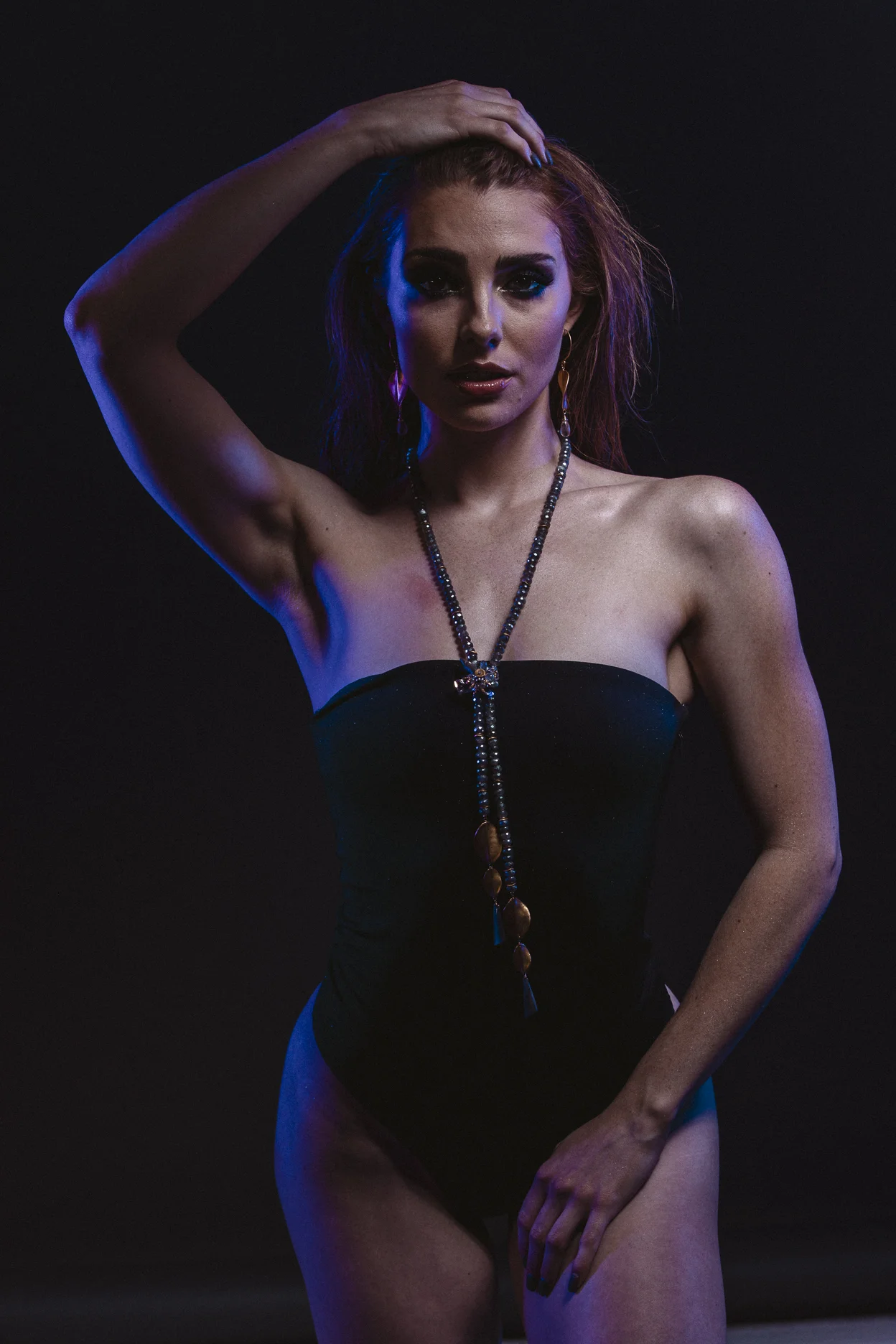 model wearing gemstone lariat double gold tassel long necklace