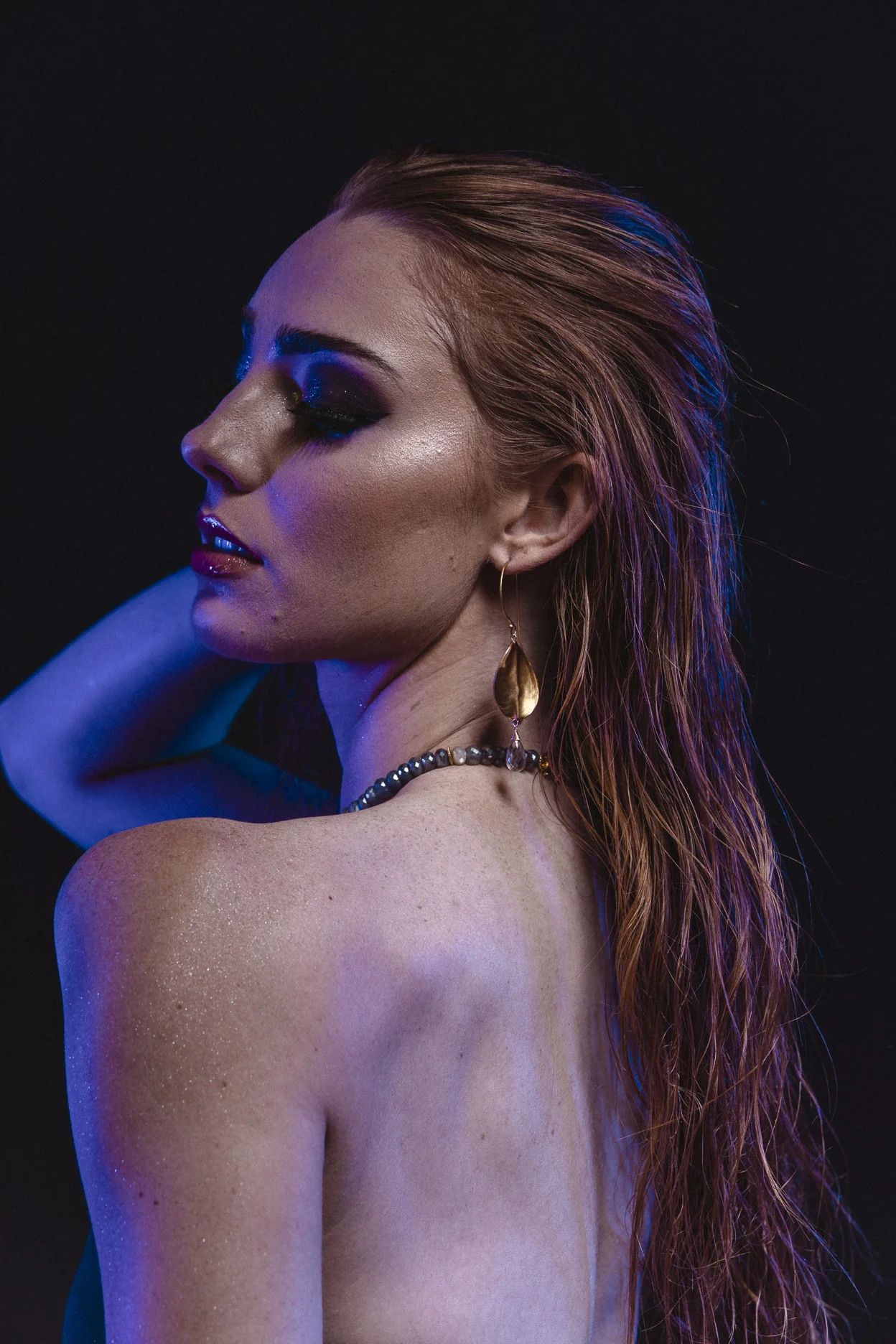 model wearing brushed gold oval drop with gemstone briolettes accent