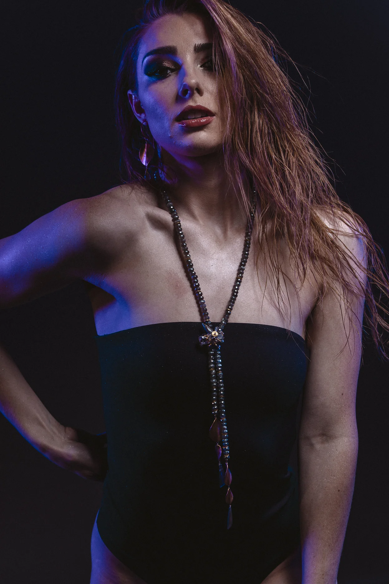 model wearing brushed gold oval drop with gemstone briolettes accent