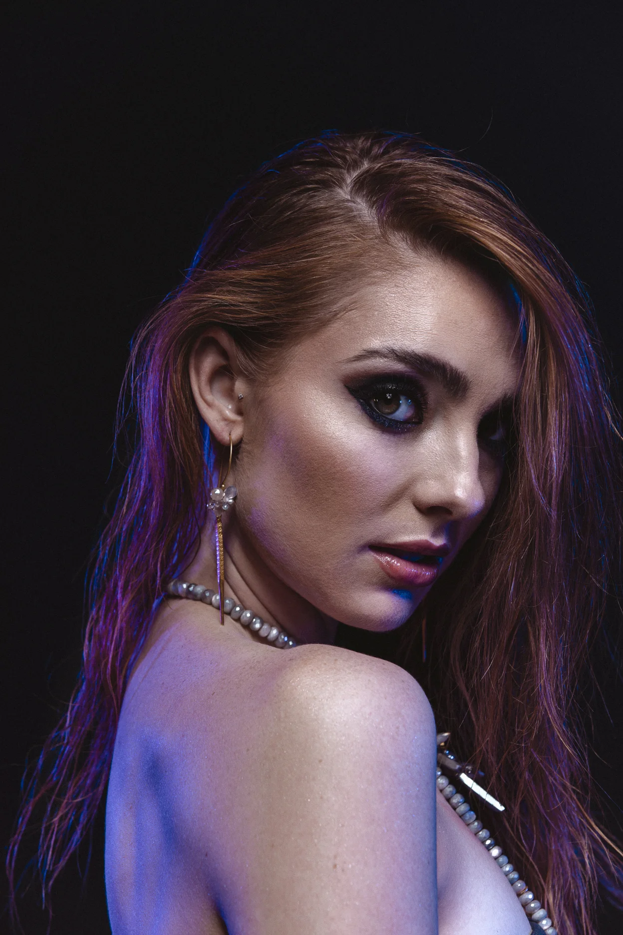 model wearing single gold spike gemstone cluster earrings