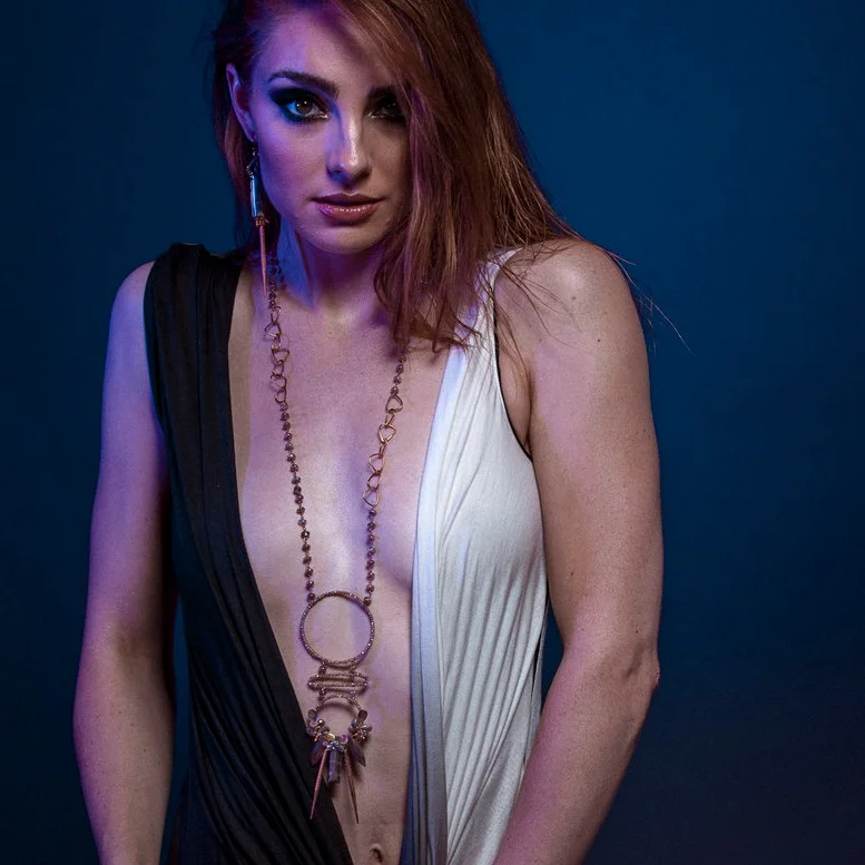 model wearing Multi circle gemstone and pearl encrusted drop pendant long gold necklace
