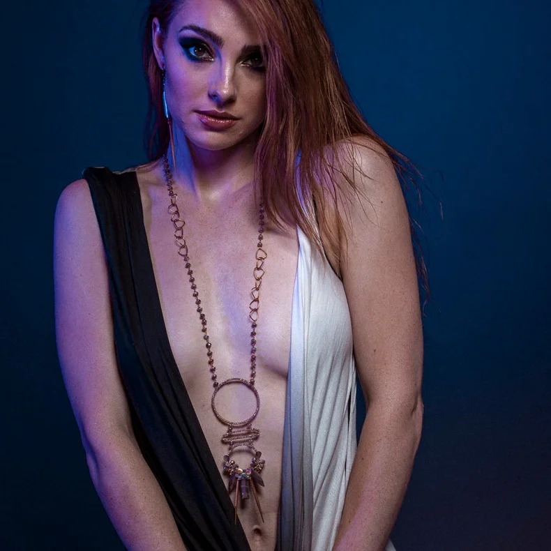 model wearing Multi circle gemstone and pearl encrusted drop pendant long gold necklace