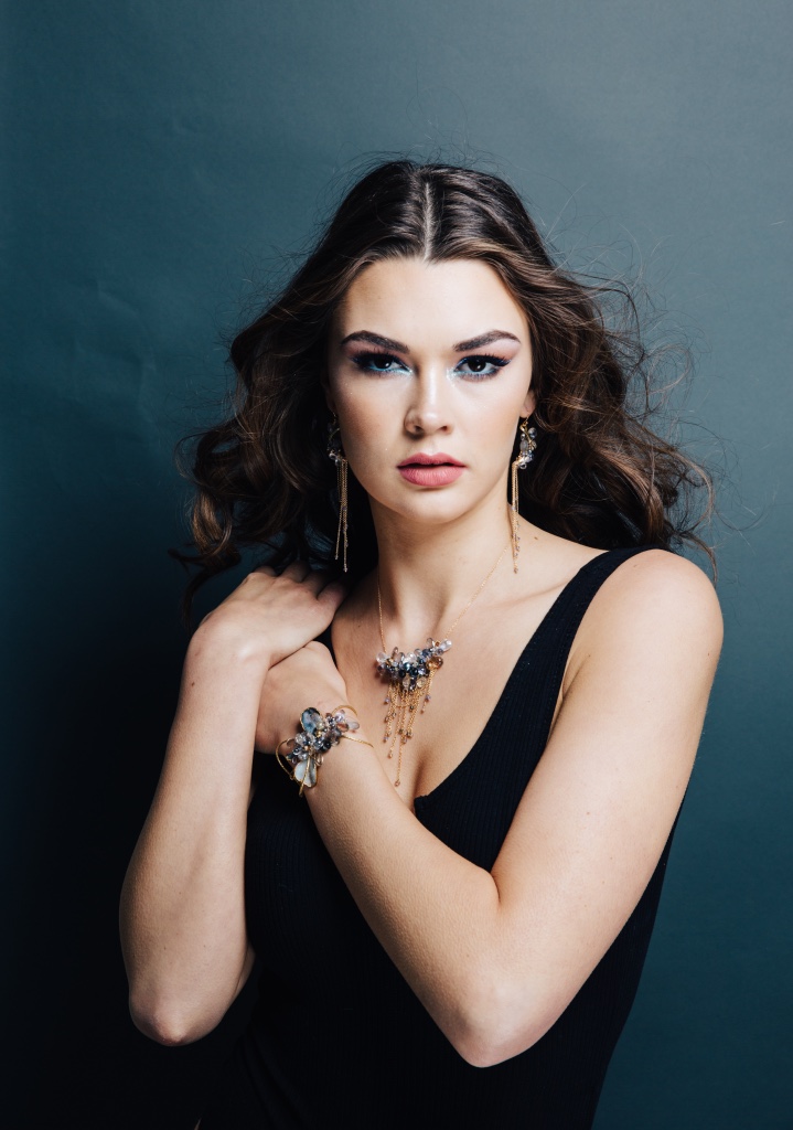 model wearing multi-drop gemstone necklace with delicate gold chains