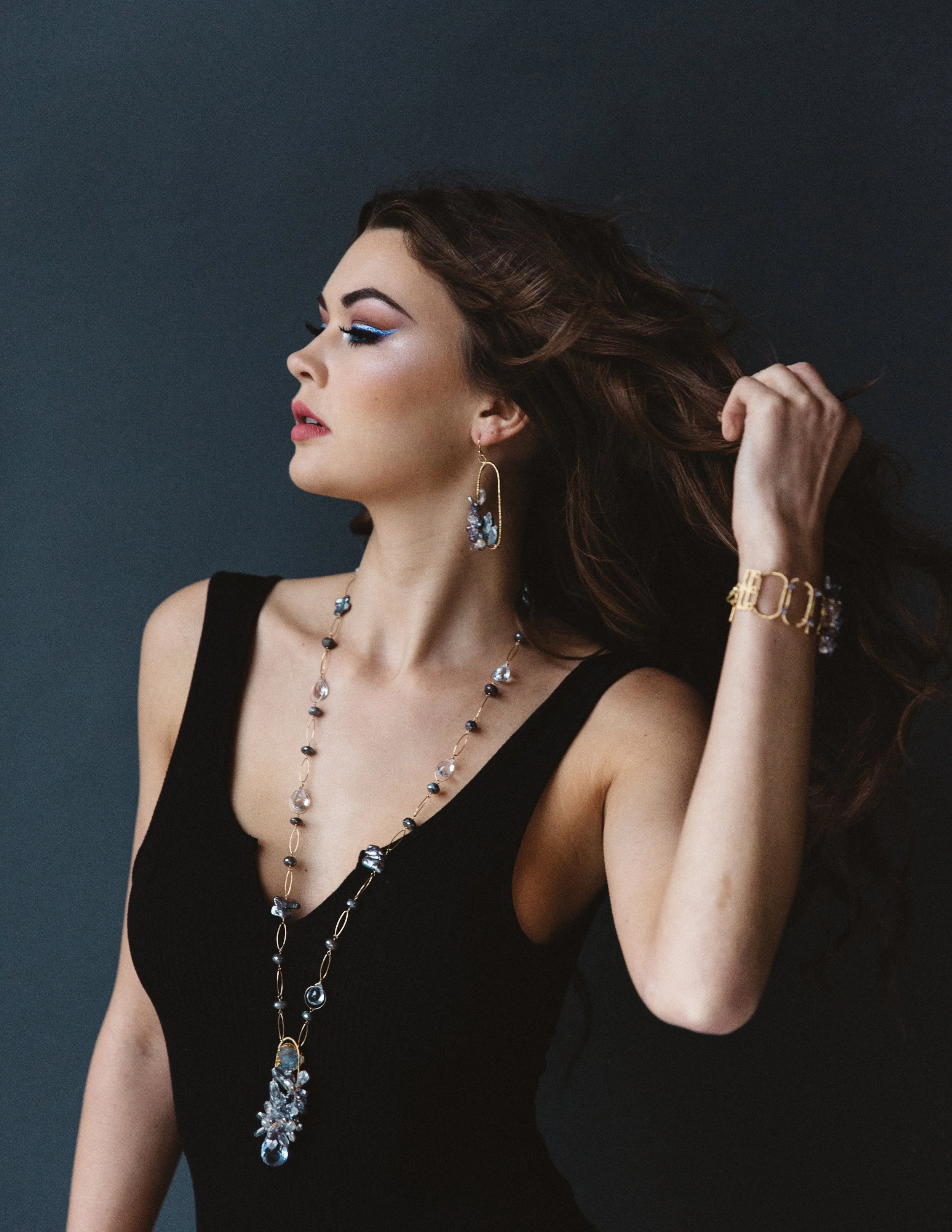 model wearing gemstone cluster pendant necklace