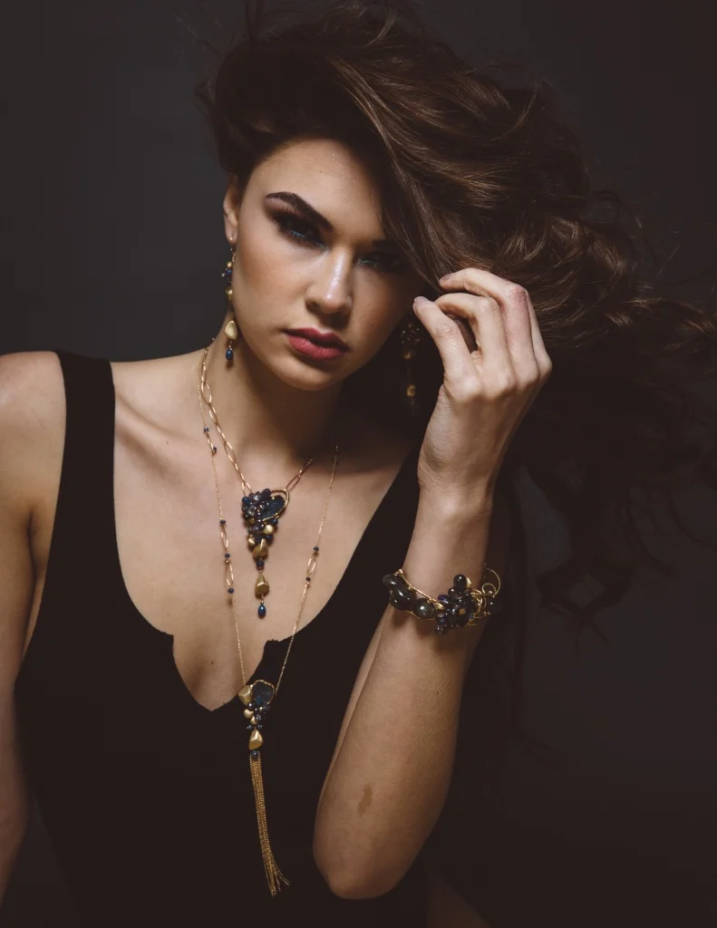model wearing gemstone and gemstone gold drop pendant necklace