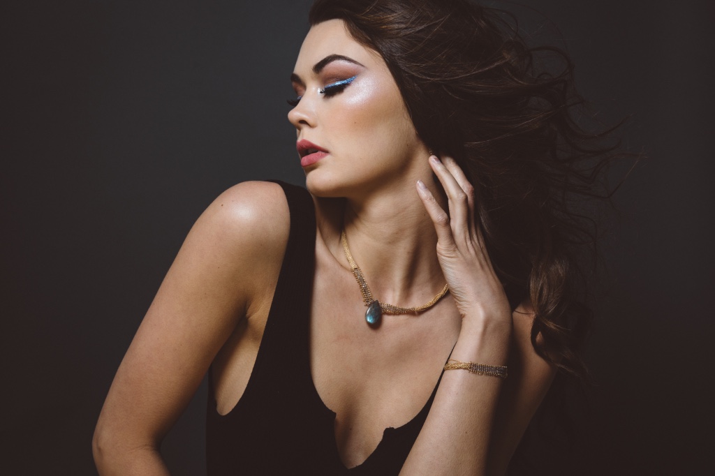 model wearing labradorite pendant and woven link chain