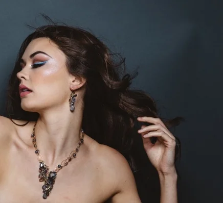 model wearing gemstone earrings