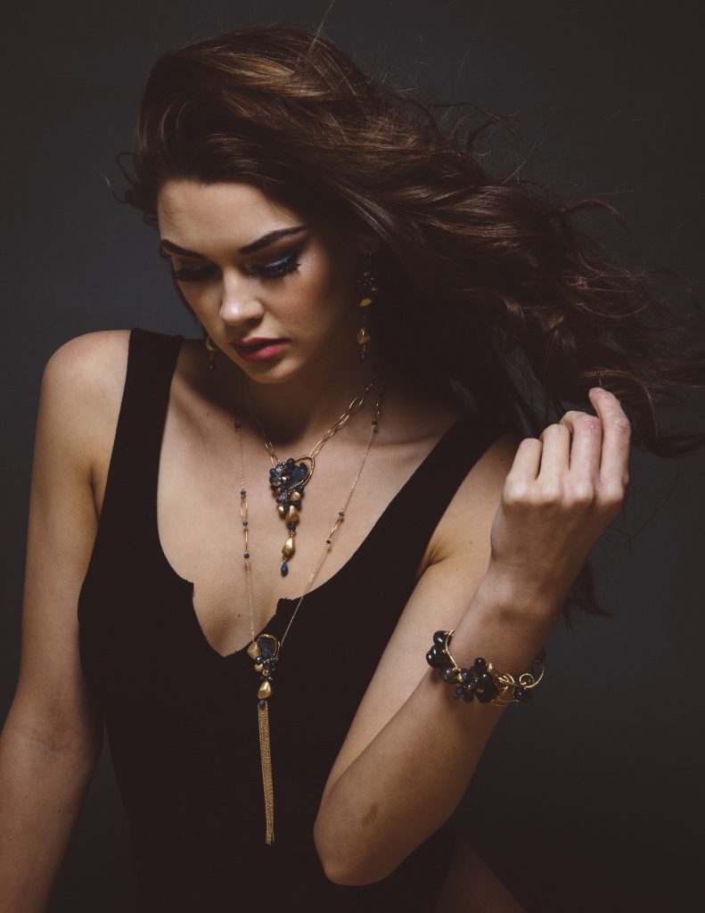 model wearing long gemstone and druzy necklace