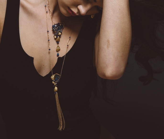 model wearing long gemstone and druzy necklace