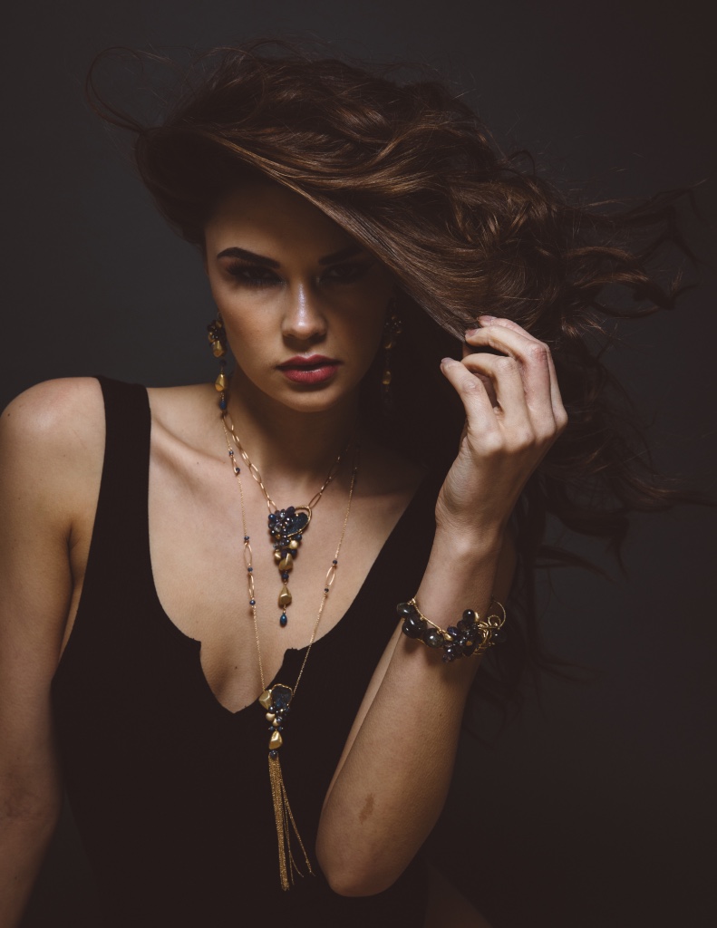 model wearing long gemstone and druzy necklace