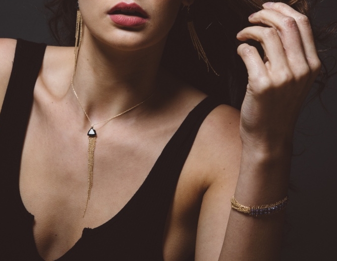 model wearing fancy cut gemstone multi drop gold chain necklace
