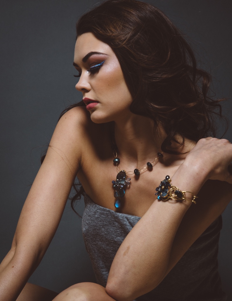 model wearing gemstone and druzy cuff bracelet