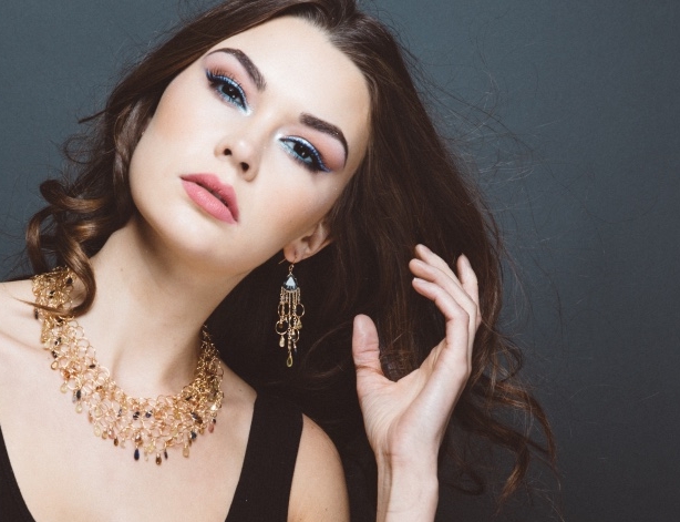 model wearing padparadscha sapphire fancy trillion cut quartz gold link multi drop earrings