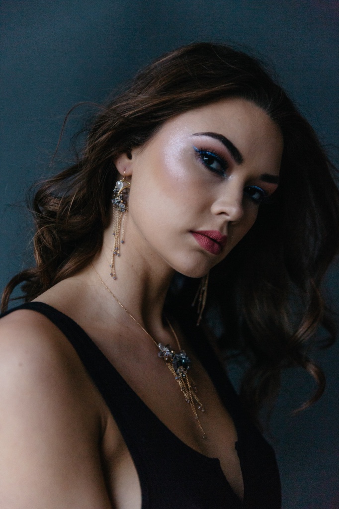 model wearing gemstone pearl multi gold chain drop earrings
