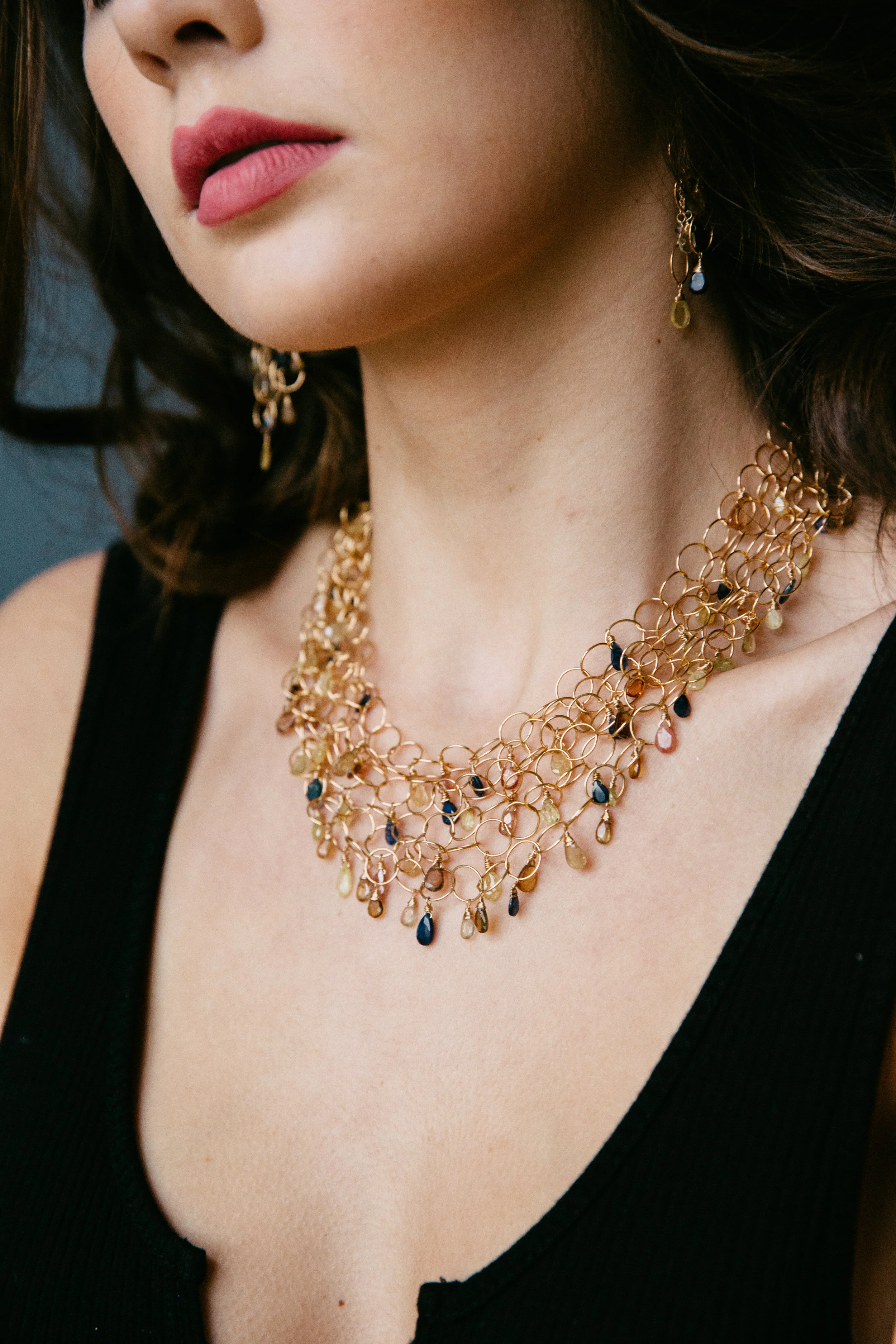 model wearing padparadscha sapphire multi layer gold link necklace