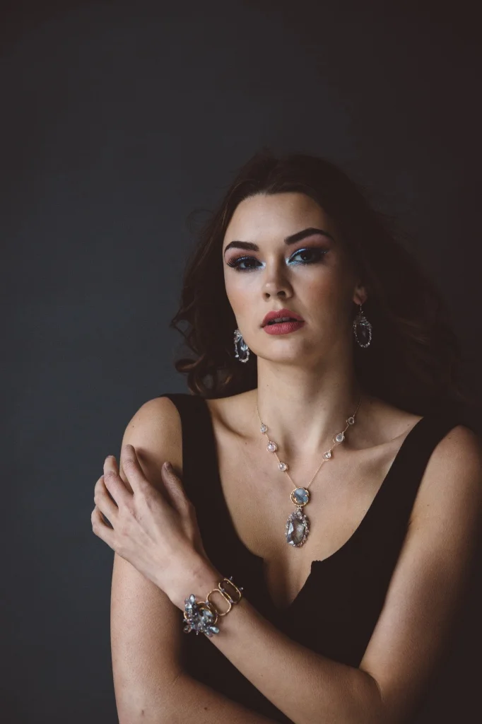 model wearing sapphire encrusted quartz pendant earrings
