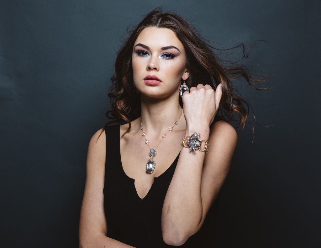 model wearing sapphire encrusted quartz pendant earrings