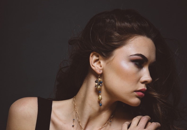 model wearing sapphire gemstone pearl gold drop earrings