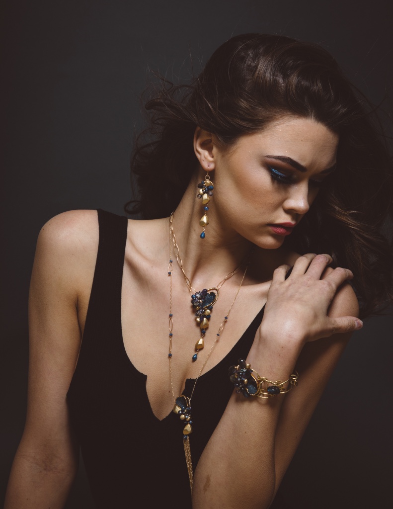 model wearing sapphire gemstone pearl gold drop earrings