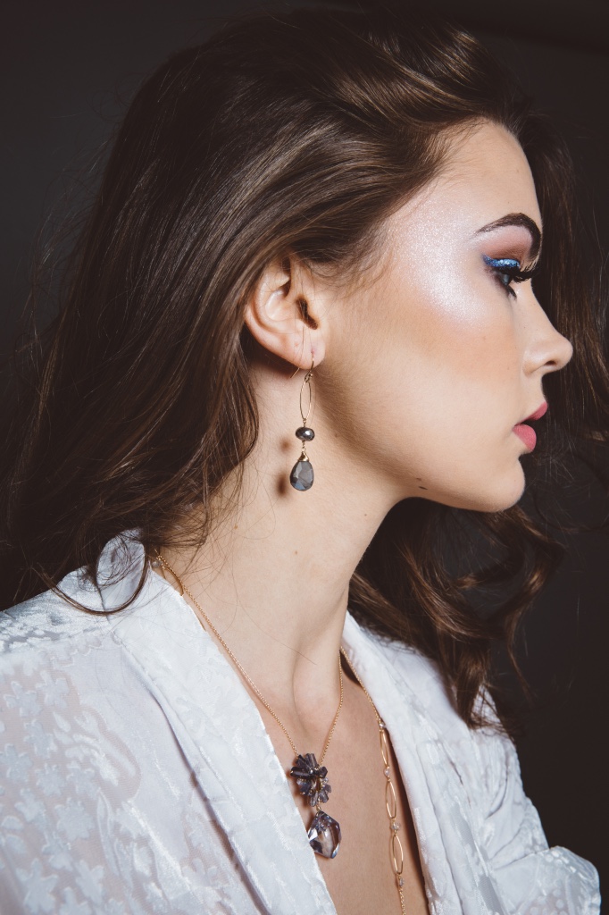 model wearing mystic labradorite pearlized moonstone gold drop earrings