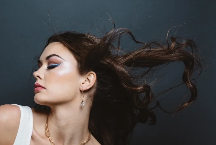 model wearing fancy cut quartz briolette gold earrings