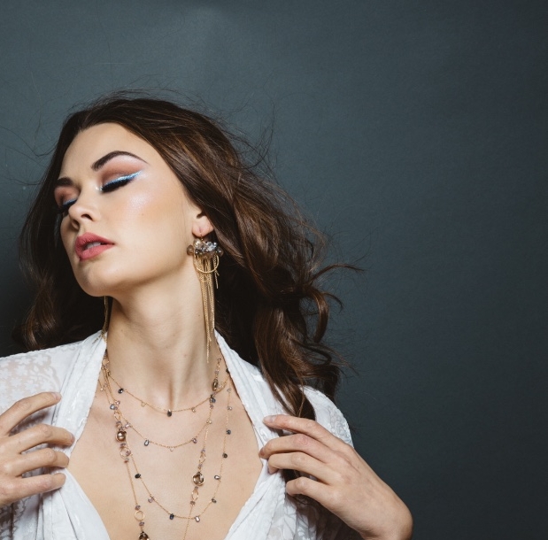model wearing sapphire gold layering necklace
