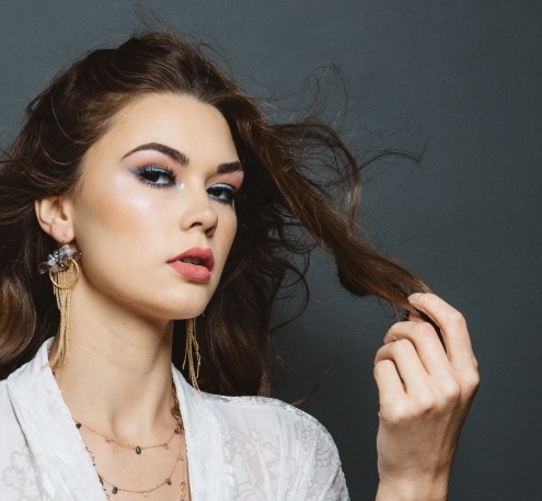 model wearing gemstone pearl gold multi chain tassel circle earrings