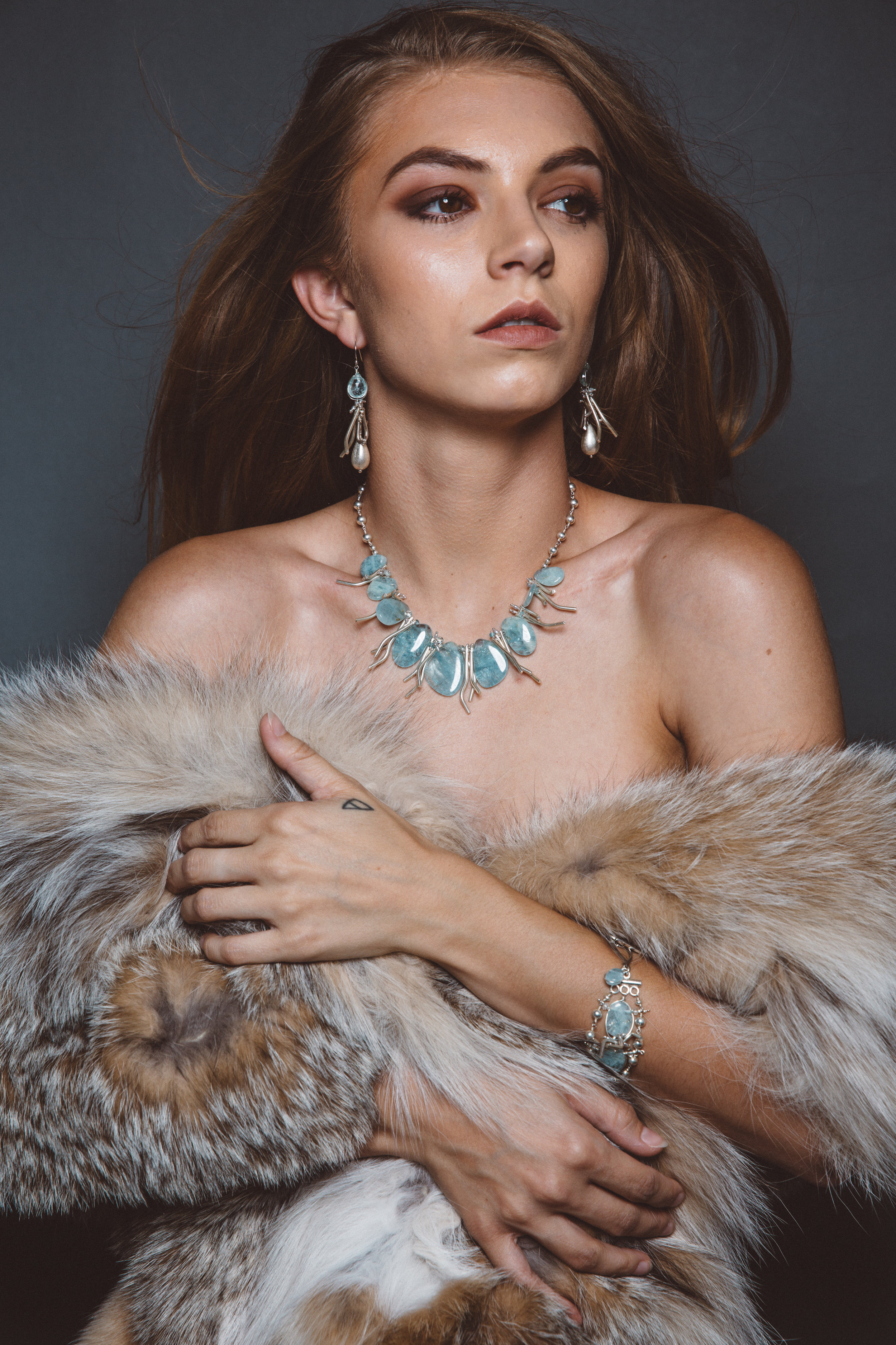 model wearing aquamarine statement collar necklace with hill tribe silver