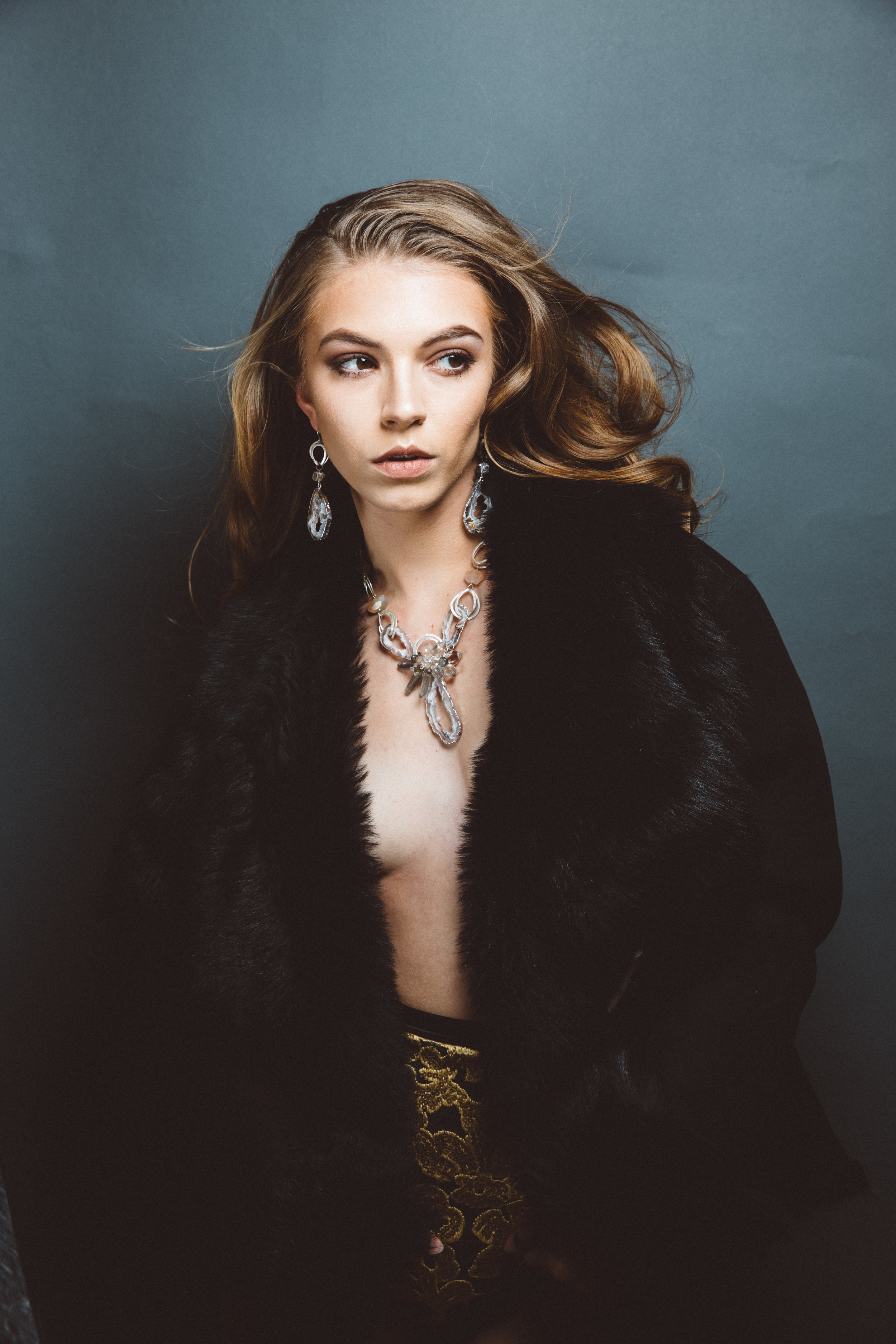 model wearing sliced geode pendant necklace with gemstones and sterling silver