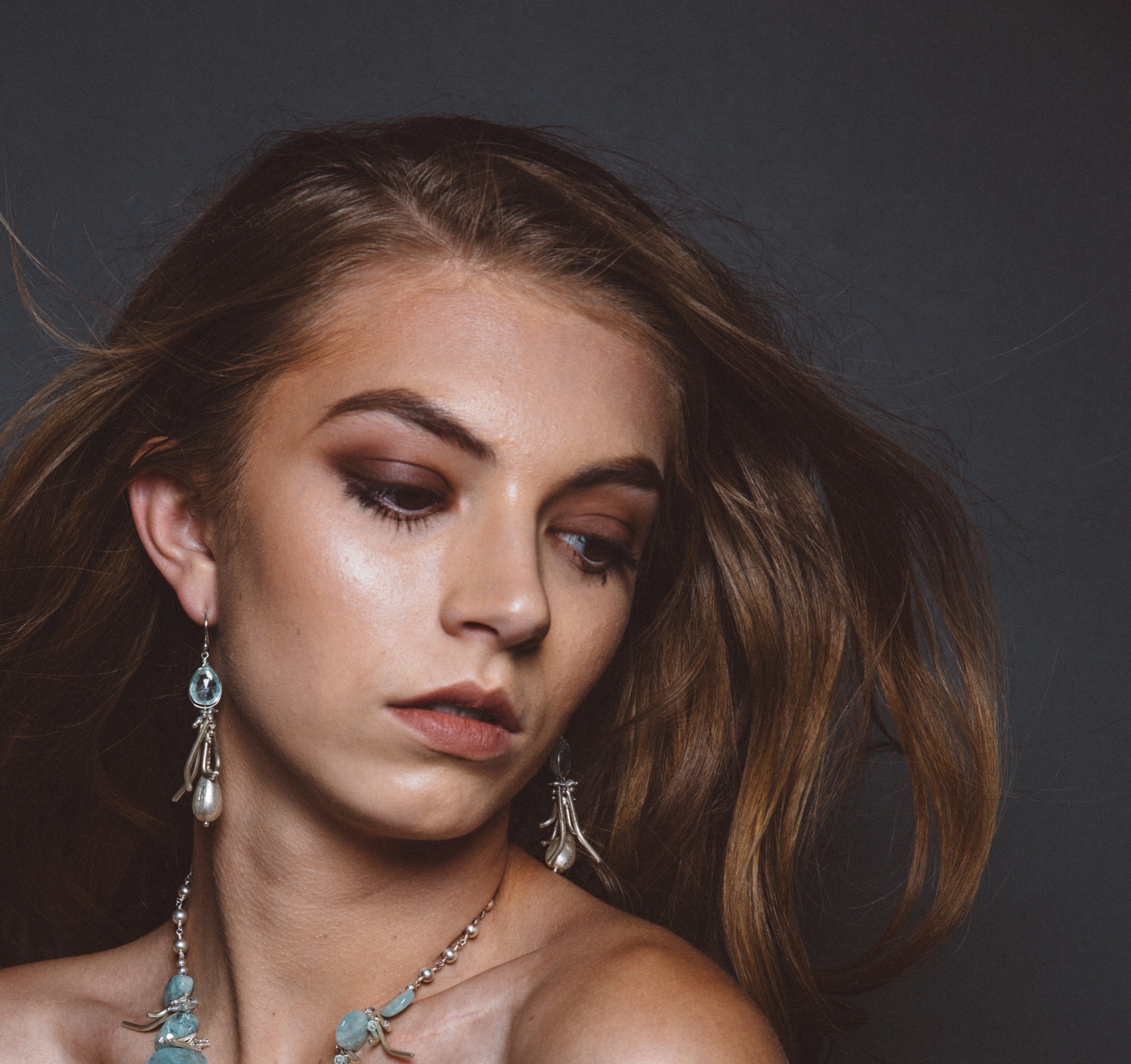 model wearing aquamarine earrings with hill tribe silver