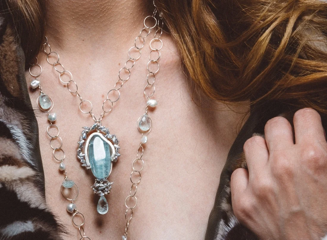 model wearing aquamarine pendant with keshi pearls and sterling silver