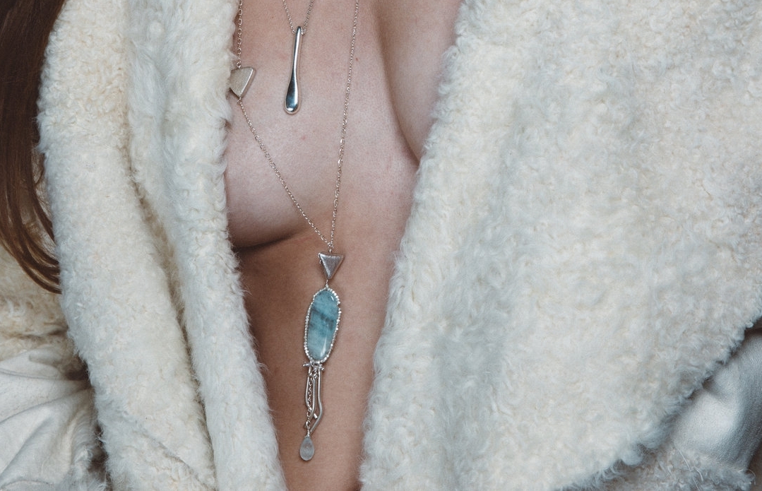 model wearing long aquamarine necklace