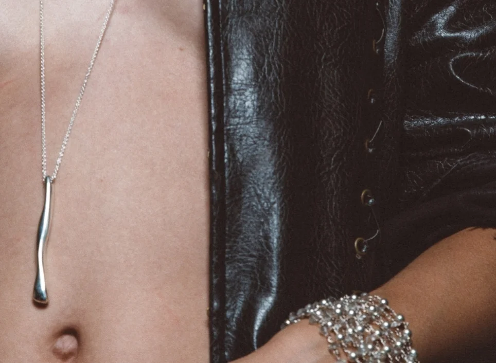 model wearing long sterling silver pendant necklace