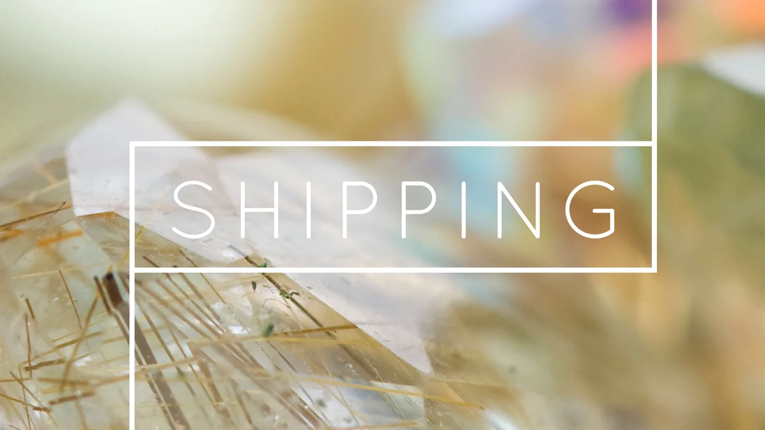 Andrea Li Designs Shipping banner: the word SHIPPING in a white frame over a close-up of golden rutilated quartz