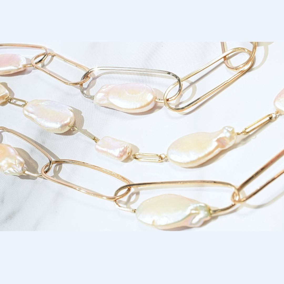 Zoomed-in section of the Baroque Pearl and Gold Multi-Strand Link Necklace, focusing on the unique texture of the baroque pearls against the gold links