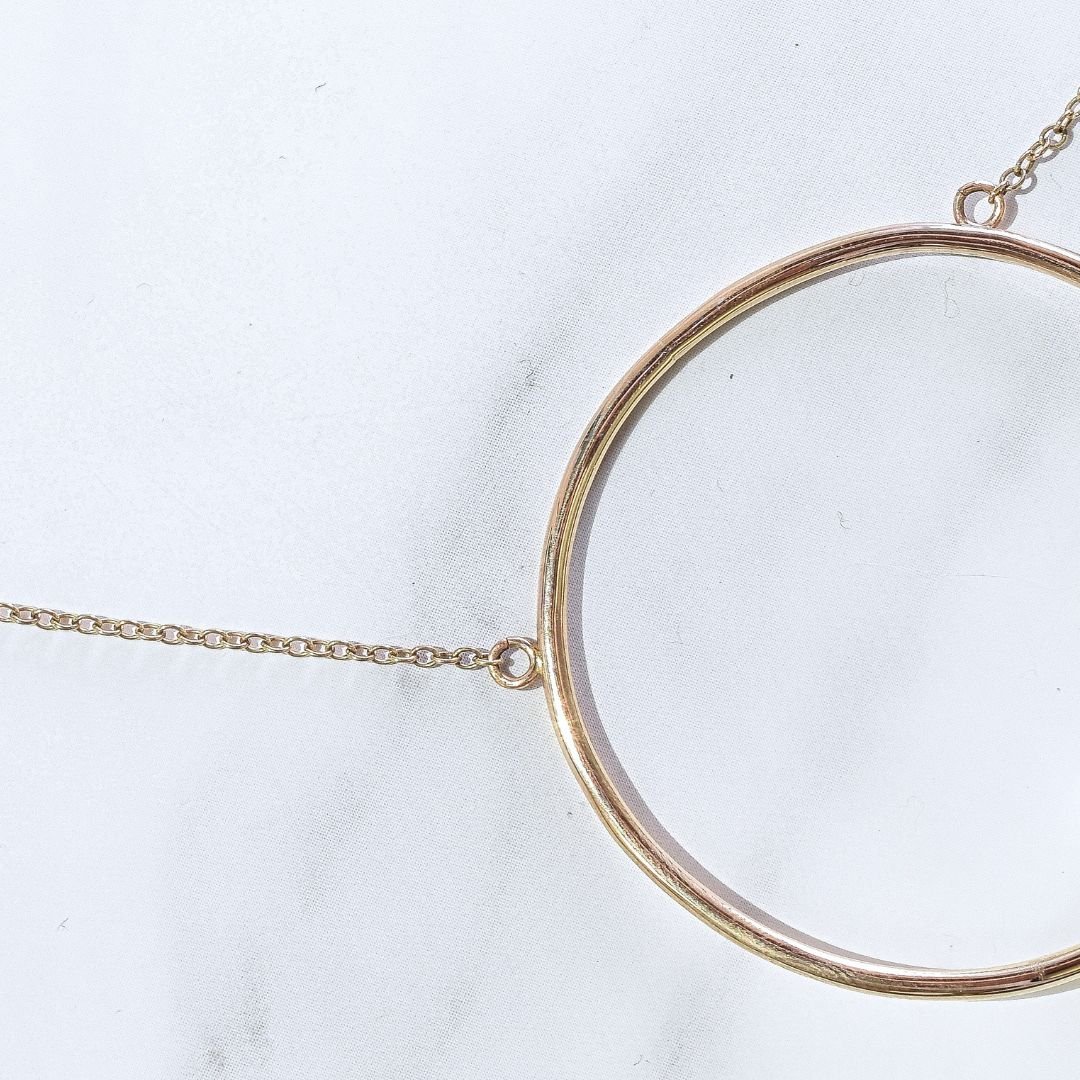 Detail shot of the Large statement Gold Open Circle Single Pearl Pendant Necklace against a white background, highlighting its craftsmanship