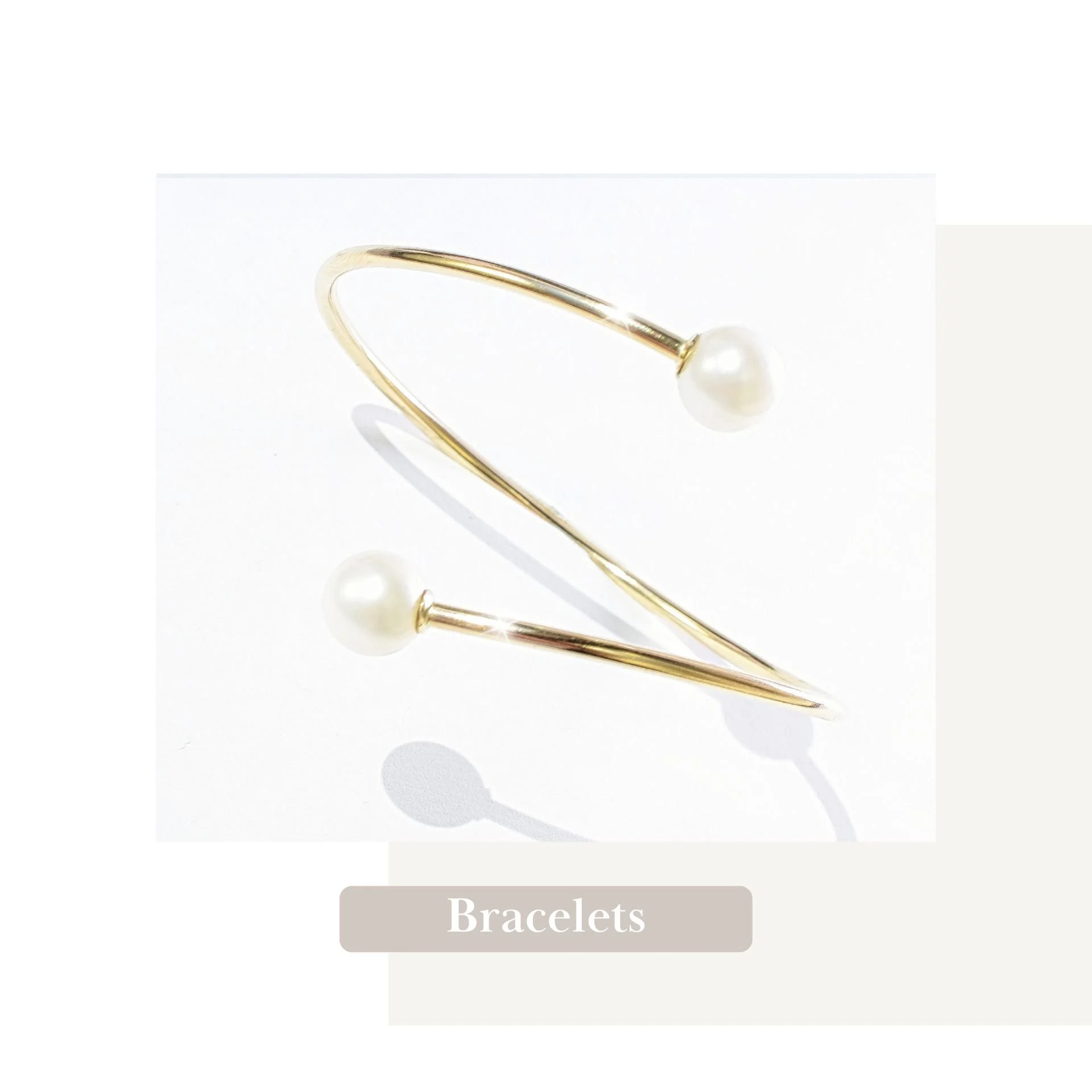 Each piece in our collection tells a story of unique statement style, like this artisan-crafted pearl and gold open-twist bangle bracelet, made for personal expression.
