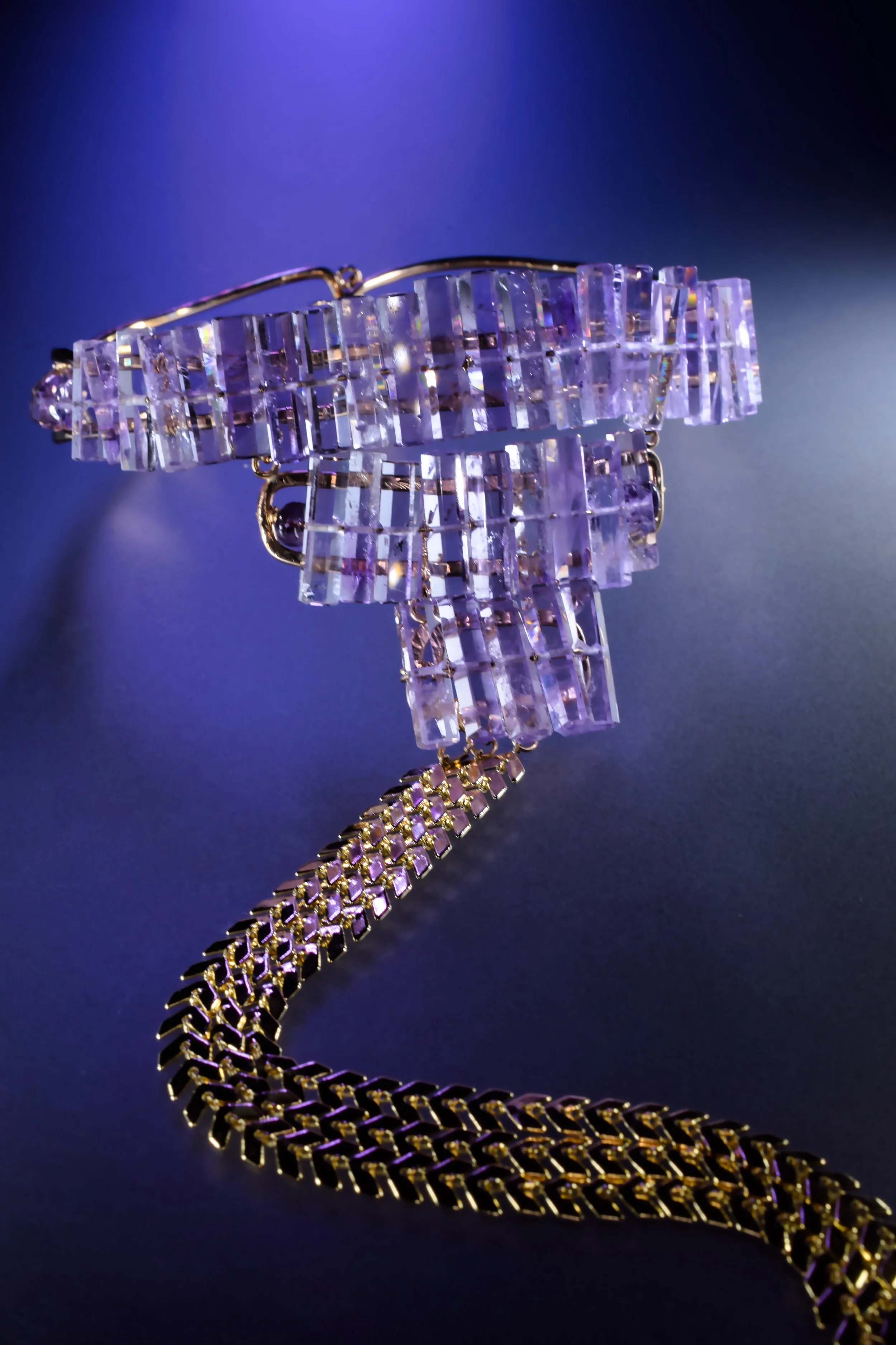 Close up tiered amethyst gemstones glowing with light coming through